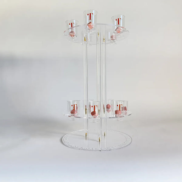 Clear acrylic display stand with multiple shelves on a white background