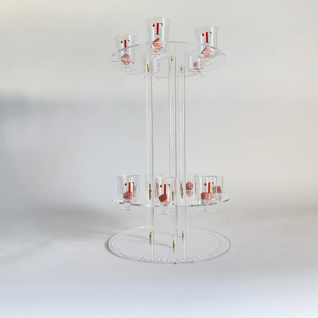 Clear acrylic display stand with multiple shelves on a white background