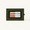 Set of bourbon cocktail mixers in a green box on a white background