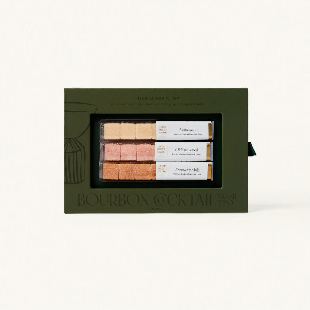 Set of bourbon cocktail mixers in a green box on a white background