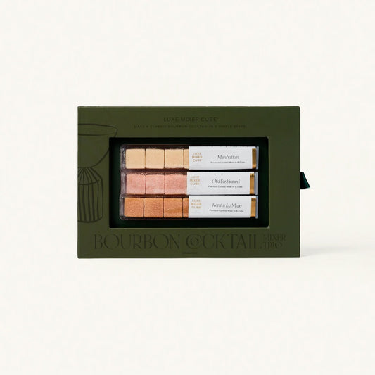 Set of bourbon cocktail mixers in a green box on a white background