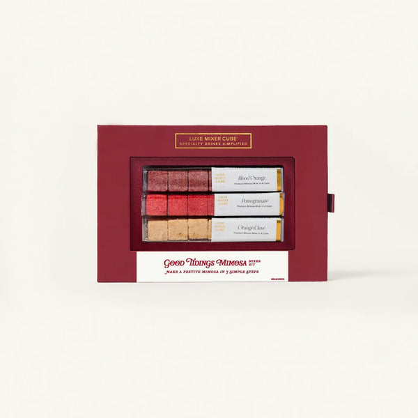 Red gift box with a window displaying three small bottles of wine on a white background