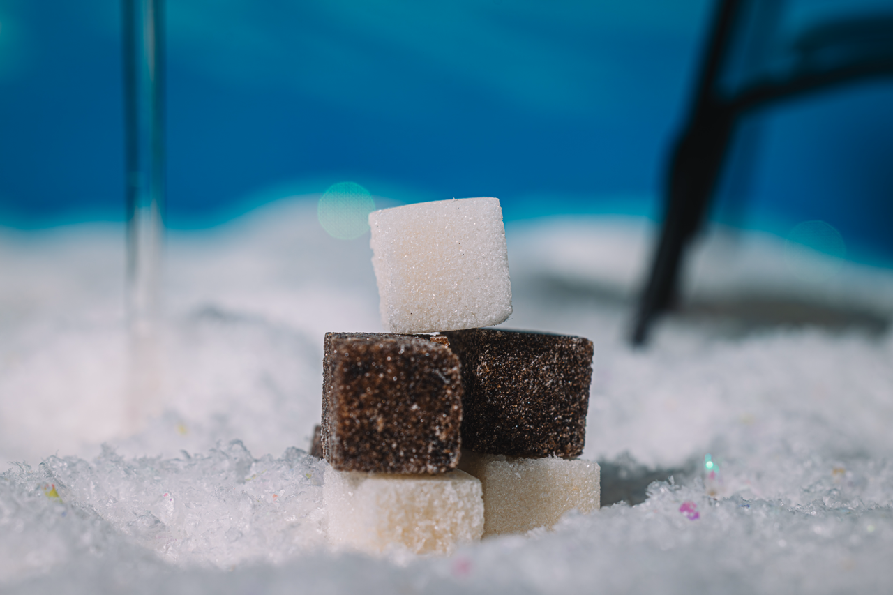 Stack of brown and white LUXE Mixer cubes on a blue snowy background