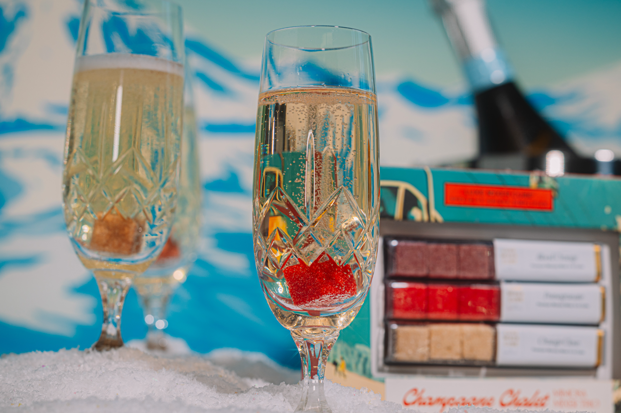 Two champagne glasses with decorative elements on a snowy background