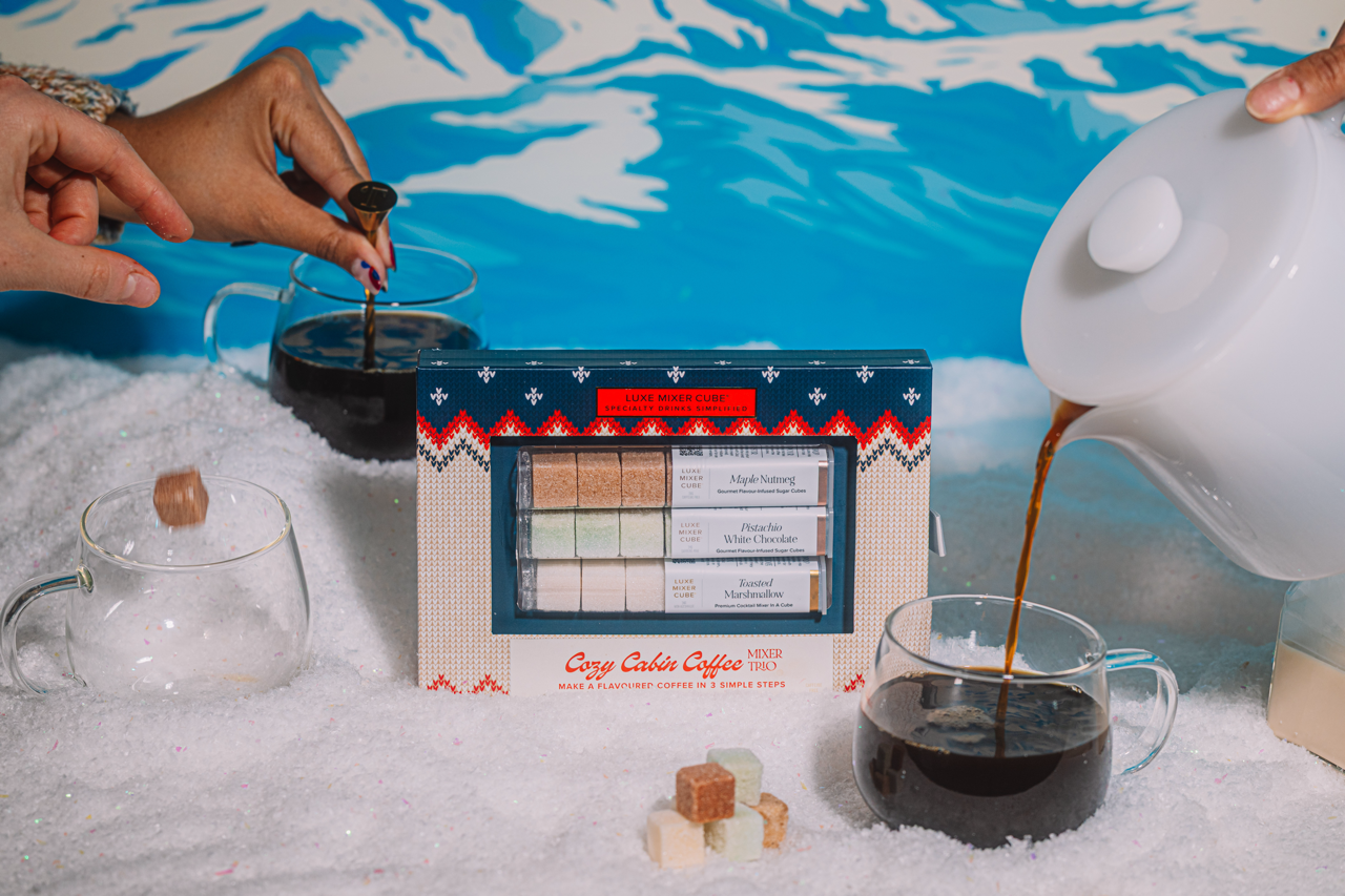 Cozy Cabin Coffee gift set with a person pouring coffee into a glass mug.