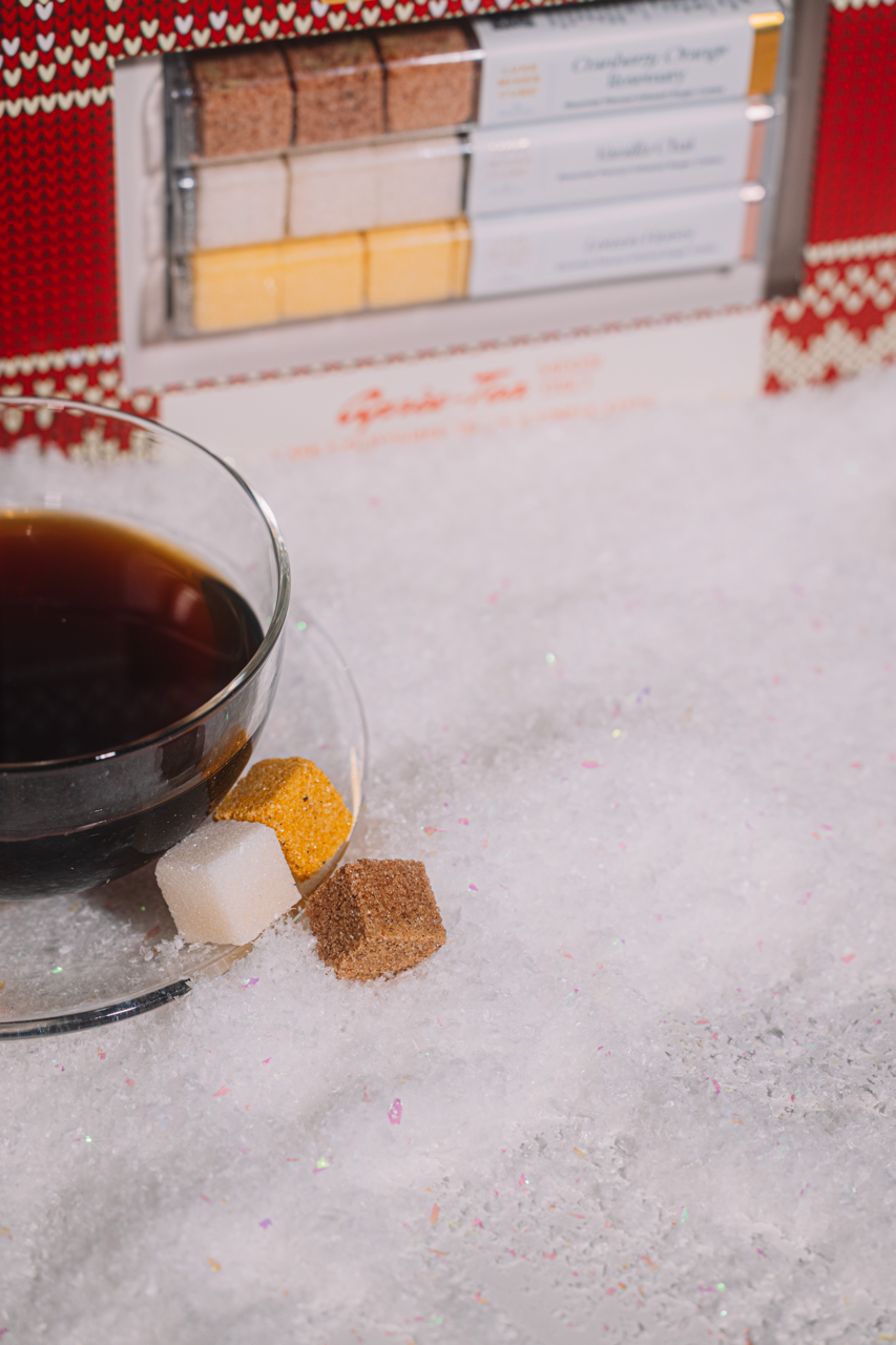 Tea cup with sugar cubes on a textured surface
