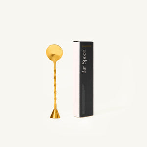 Gold bar spoon with packaging on a white background