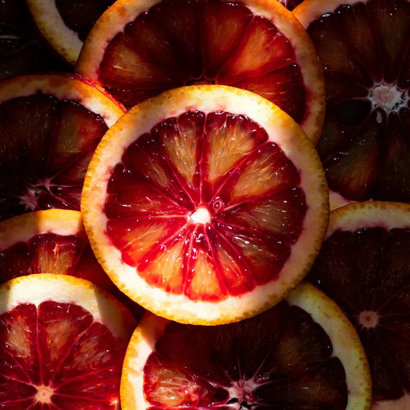 Close-up of sliced blood oranges with a dark background